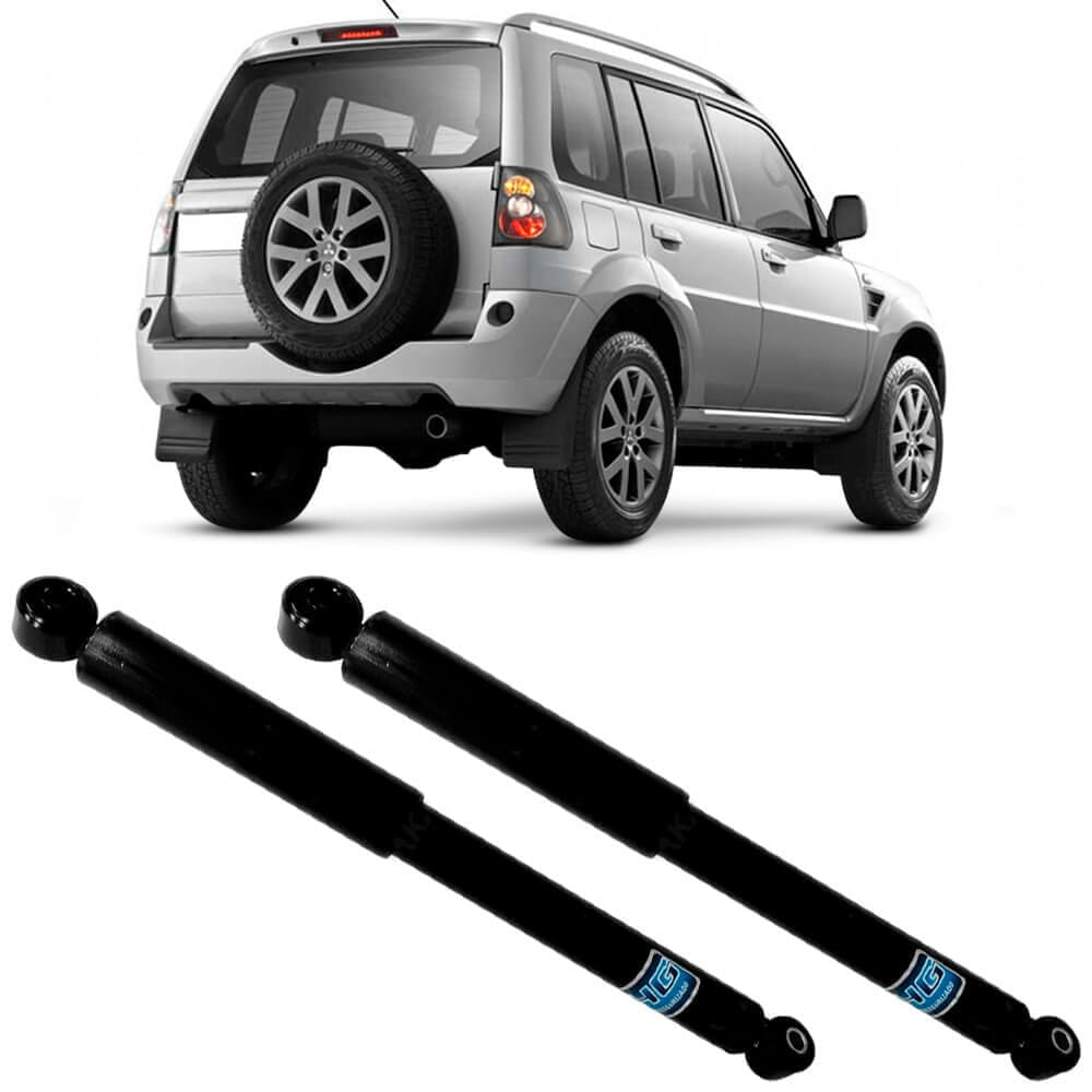 Dois amortecedores traseiros pretos para Mitsubishi Pajero 2000 a 2015 diante de veículo prata